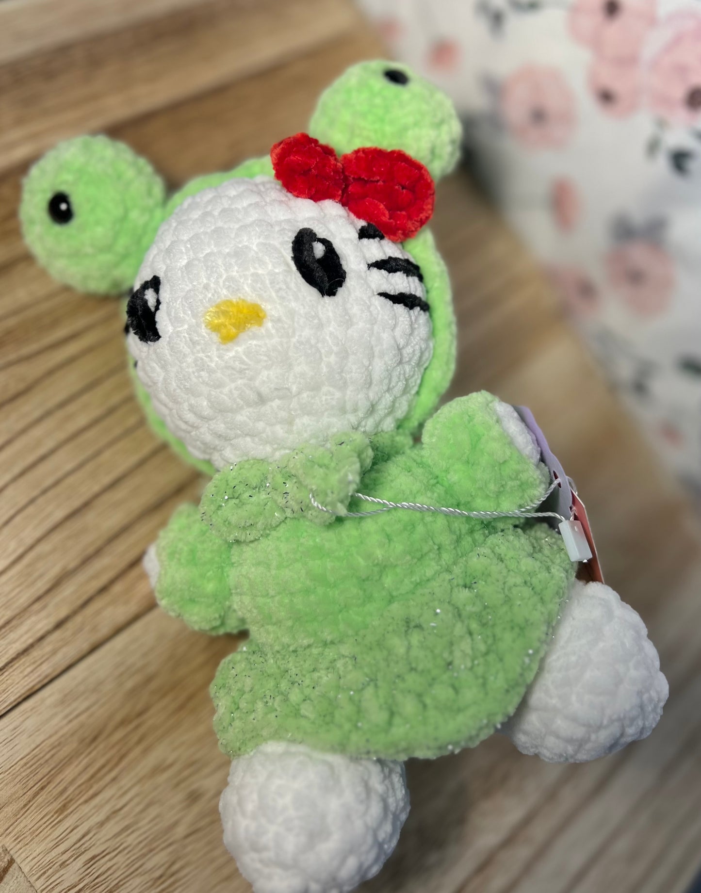 Crochet hello kitty in a frog outfit